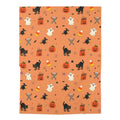 Classic Halloween blanket featuring pumpkins, ghosts, black cats, witches and skeletons on an orange background