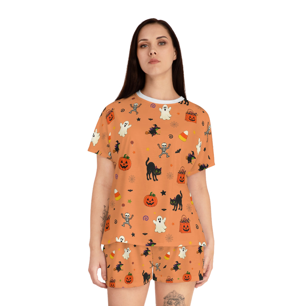Cute spooky pajamas for women displayed with Halloween pumpkins and candles