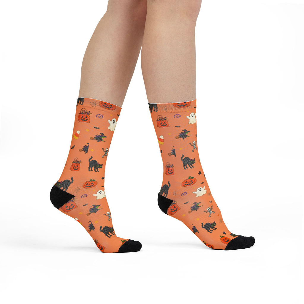 Cute spooky socks featuring a Halloween pattern of pumpkins, witches, ghosts and bats