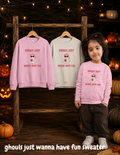 Toddler girl wearing a pink Halloween sweater featuring a cute ghost, bow, sunglasses and pumpkin with “Ghouls Just Wanna Have Fun” design.