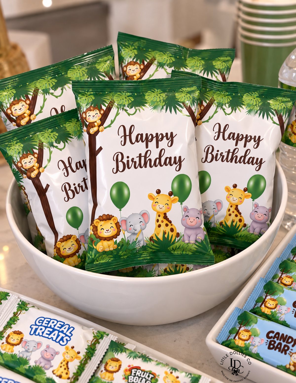 Wild One first birthday favor chip bags featuring giraffes, lions, elephants, balloons, and tropical jungle leaves