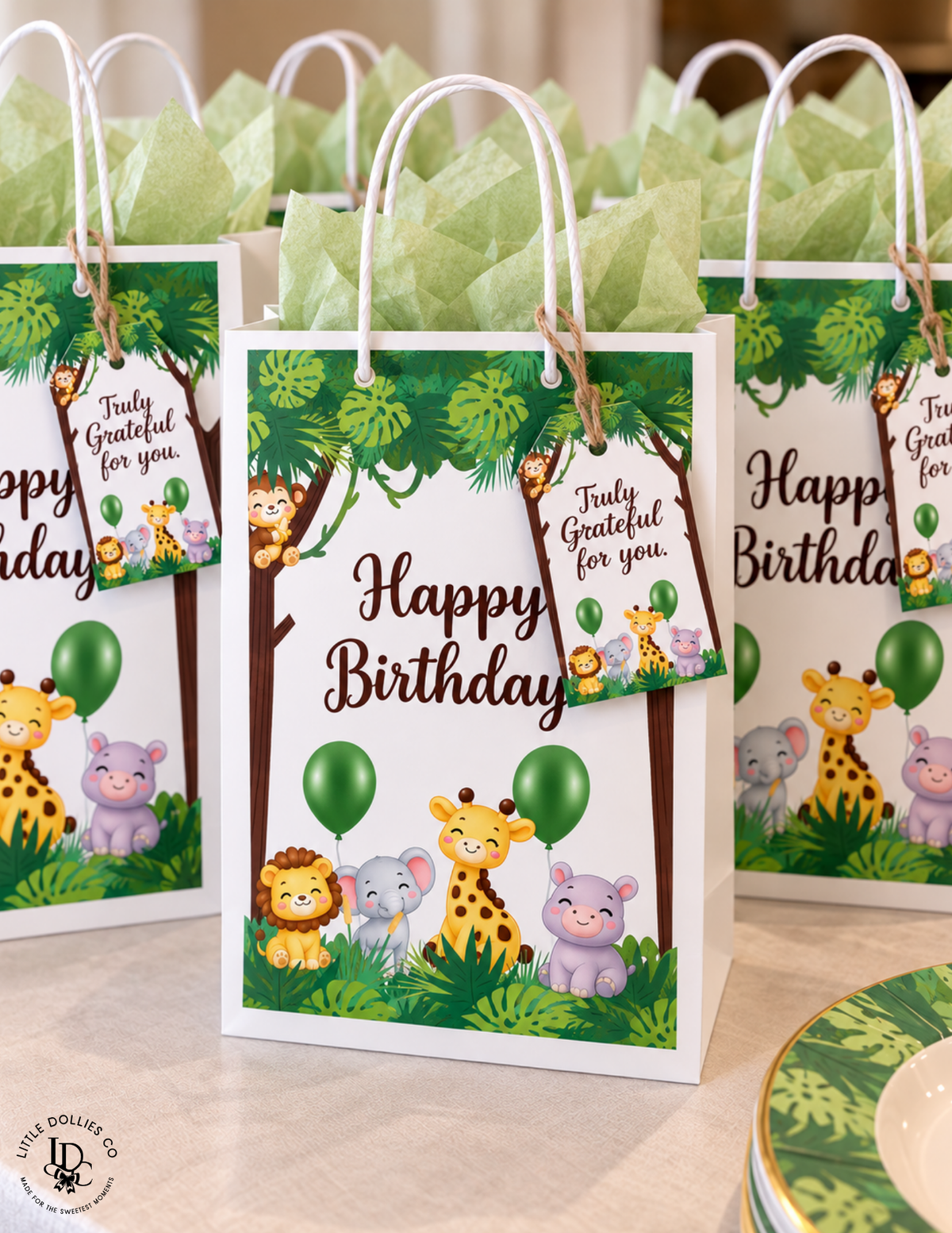 wild One first birthday favor gift bags featuring giraffes, lions, elephants, balloons, and tropical jungle leaves